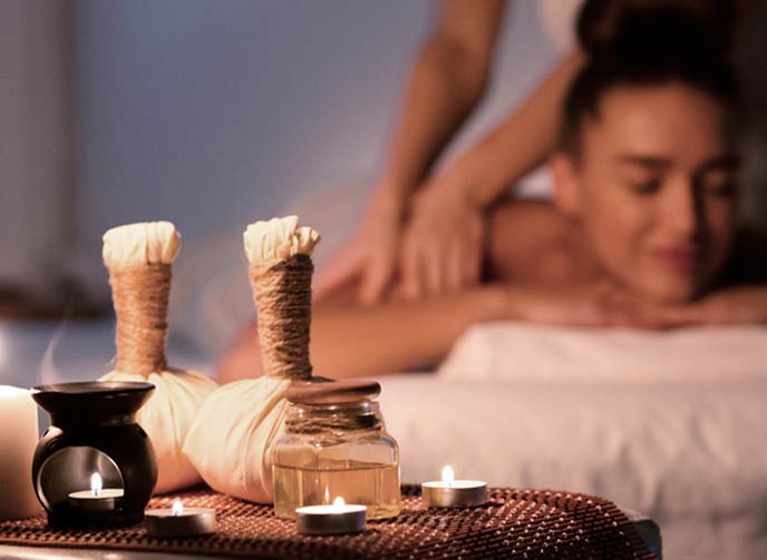 A Thai Massage Centre with Thai herbal balls and a lady getting a relaxing massage from a Thai Masseuse